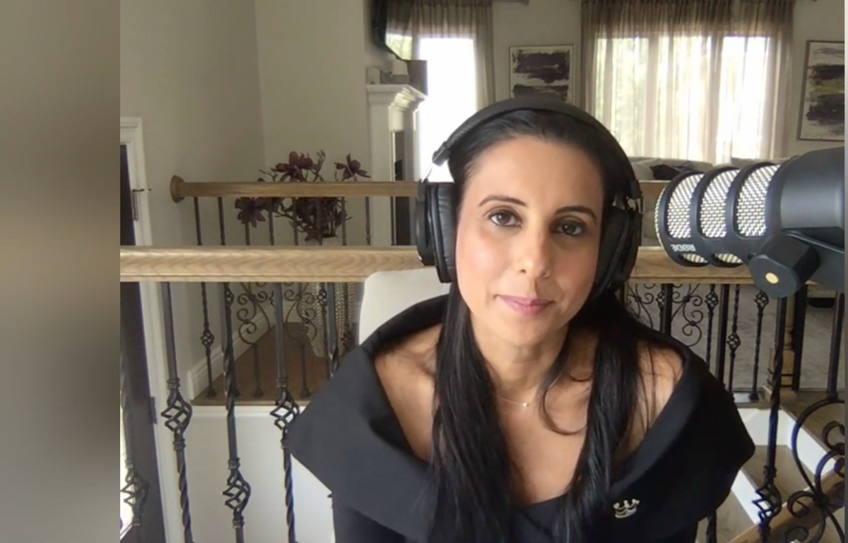 Kanika Chadda Gupta, host of That's Total Mom Sense podcast, recording in a stylish home studio.