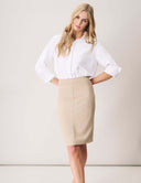 Woman wearing the Blossom Blouse Bodysuit with blouson sleeves and a fitted beige skirt, showcasing elegant office style.