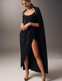 Model wearing the Come Closer dress with a high split-leg and optional cape, showcasing modern glamour and elegance.