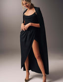 Model wearing the Come Closer dress with a high split-leg and optional cape, showcasing modern glamour and elegance.