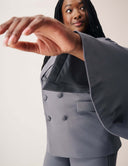 Model wearing the Cool Intentions Blazer with batwing sleeves and satin lapels, showcasing a stylish pose.