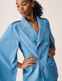 Model wearing the Cool Intentions Blazer with batwing sleeves and satin lapels, showcasing its elegant design.