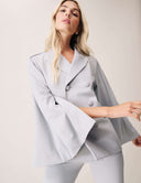 Model wearing the Cool Intentions Blazer with batwing sleeves and satin lapels.