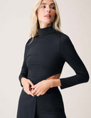 Model wearing the Cut to the Chase Top showcasing a sophisticated black design with a distinctive cutout.