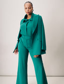 Model wearing a stylish teal Dahlia Blazer outfit with wide-leg pants, showcasing a sleek look and premium fabric.
