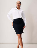 Model wearing the Flora Pencil Skirt with a high-rise waistband, showing a sleek silhouette and double welt pockets.