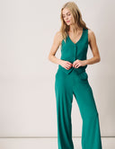 Model wearing the Gardenia Vest in green with button closure and tailored silhouette.