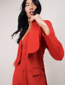 Model wearing a stylish red Magnolia Blazer with peak lapels and flap pockets, showcasing versatility and comfort.