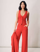 Woman modeling the Magnolia Vest in vibrant red, styled with matching wide-leg pants, exuding effortless sophistication.