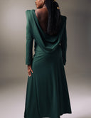 Model showcasing the No Turning Back dress with a draped open back and cowl, highlighting its elegant silhouette.