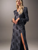 Model wearing the No Turning Back dress with long sleeves, V-neckline, and high slit for elegant movement.