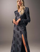Model wearing the No Turning Back dress with long sleeves, V-neckline, and high slit for elegant movement.