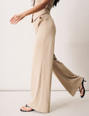 Model wearing beige Peony Pant with high-rise waistband and tailored straight leg for a polished look.