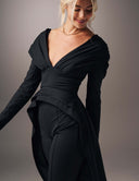 Model wearing the Promise Me Nothing Top with deep V-neckline and flowing high-low hem.