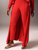 Model wearing the Promise Me Nothing Pant in red, featuring a high-waisted design and stylish pintuck seams.