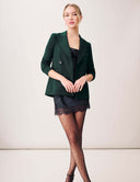 Starry Night Blazer: The Sustainable Edit in Dark Laurel paired with a stylish black dress and polka dot stockings.