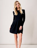Model wearing Tulip Dress in black, featuring long sleeves and a flattering flared skirt.