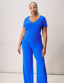 Model wearing a blue V-Neck Luxe Tee paired with matching wide-leg pants, showcasing stylish comfort and elegance.