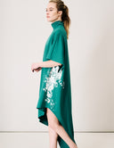 Elegant Willow Dress with mock neck and asymmetrical hem, featuring floral design in a rich green color.
