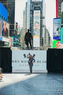 A model showcases workwear at Mrs. Monica Bear's fashion show in Times Square, New York City.