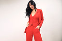 Model showcasing bold red suit, representing New York Fashion Week Trends You Can Wear Now - Fall 2025.