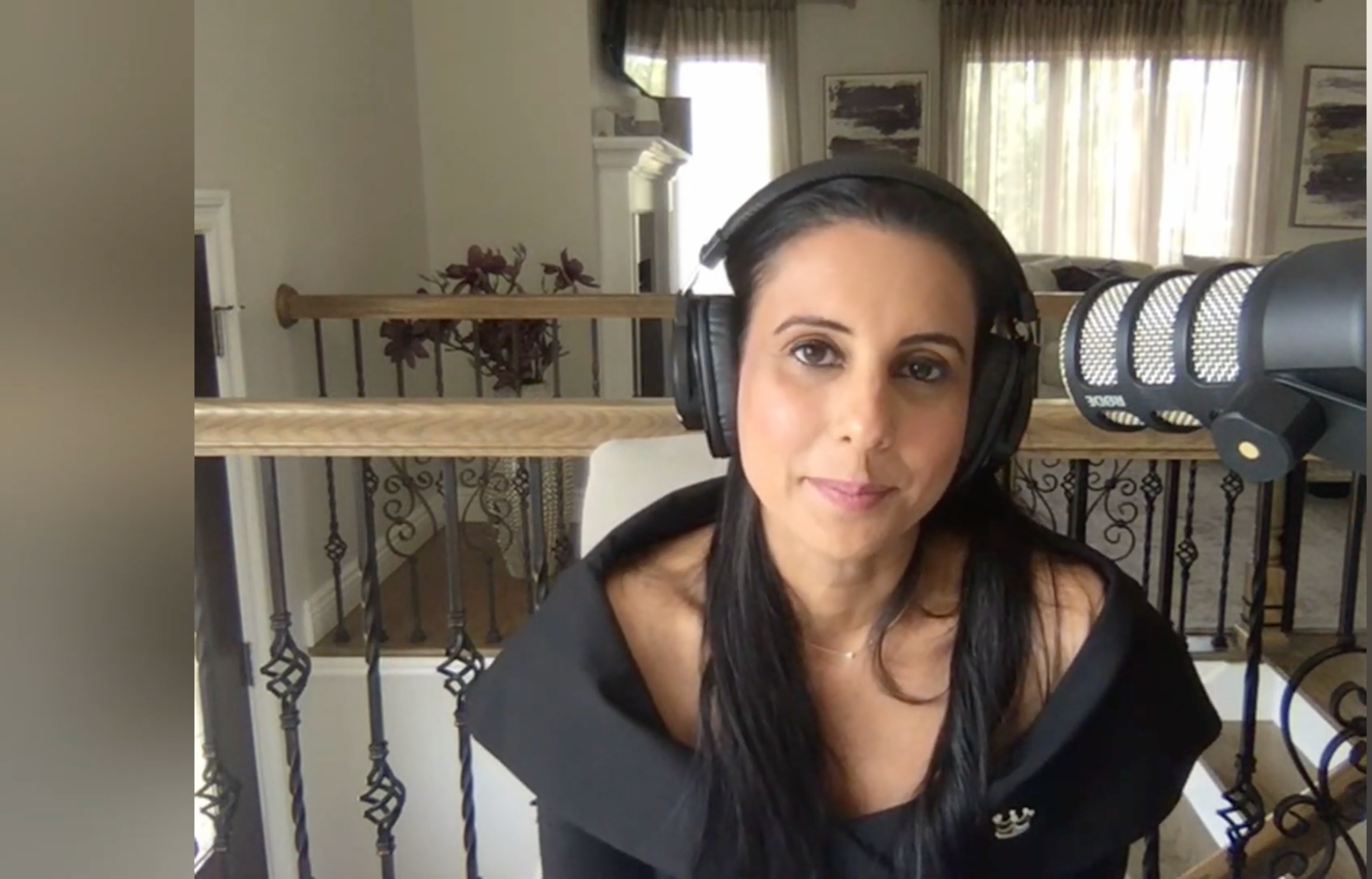 Kanika Chadda Gupta, host of That's Total Mom Sense podcast, recording in a stylish home studio.