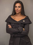 Podcast Host & Creator, Kanika Chadda-Gupta posing confidently in an elegant black dress with a stylish collar.