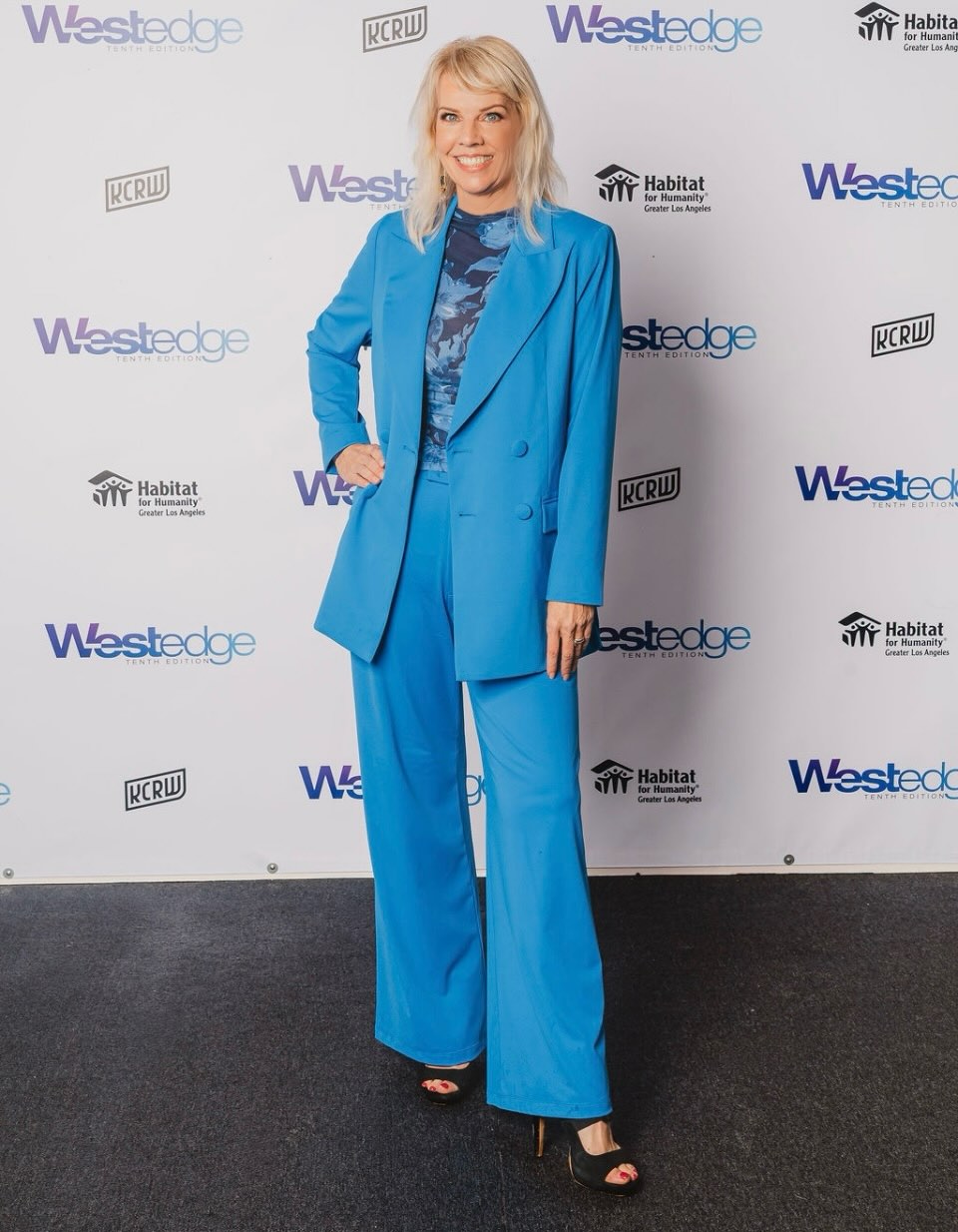 Strategic Marketer, Event Producer & Entrepreneur, Megan Reilly in a stylish blue suit at a Westedge event.