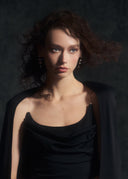 Model is wearing the Come Closer dress in Obsidian