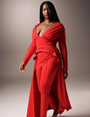 Model showcasing the Promise Me Nothing - Rosso set, featuring a deep V-neck top and high-waisted tapered pants in red.