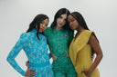 Three models showcase vibrant fashion in colorful outfits: blue, green, and yellow against a neutral background.