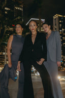 Three women in stylish suits showcasing the Perfect Form Set - Signature Black in a chic urban setting.