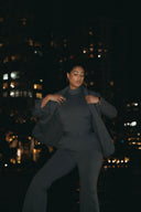 Model showcasing the Perfect Form Set - Graphite in an urban night setting, highlighting sophisticated tailoring and style.