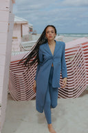 Keep It Moving Set - Marina in blue, featuring an open back tux jacket and sleek pull-on pants, showcased on the beach.