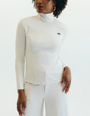 Enza Marie Top featuring a white mock neck long bell-sleeve design, perfect for showcasing elegance and style.