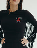 Stylish black jumpsuit with fringe detailing, a vibrant pocket design, and long sleeves, perfect for any occasion.