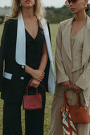 Model showcasing Magnolia Suit Set - Black Rose/Jasmine featuring stylish blazers and chic accessories.