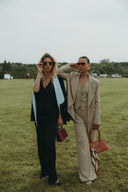 Models showcasing the Magnolia Suit Set - Black Rose/Jasmine in a field, highlighting modern elegance and style.