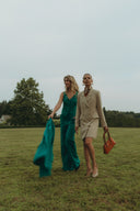 Two models showcasing stylish outfits outdoors, featuring the elegant Gardenia Vest in a chic look.