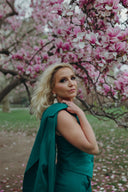 Lee Evans Lee in suit separates from the Garden Collection in the color Poison Ivy in a park with cherry blossoms in bloom
