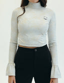 Elegant Mad Hatter crop top with printed lace, bell cuffs, and a stylish tea cup design, perfect for any occasion.