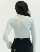 Back view of the Mad Hatter Top featuring intricate lace, bell sleeves, and a cropped fit, perfect for stylish versatility.