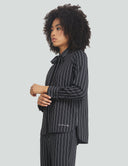 Striped night top in black with bow detail, showcasing stylish cuffed sleeves and a fitted silhouette. Perfect for any occasion.