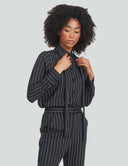Woman wearing a striped night top with a bow detail, styled for a chic, versatile look suitable for any occasion.