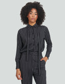 Model wearing a black and white striped night top with a removable bow and cuffed sleeves, perfect for various occasions.