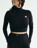 Black fitted long sleeve cropped top with elegant cup pin, perfect for stylish comfort during any occasion.