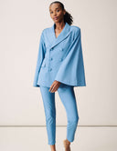 A model wearing the Cool Intentions Blazer in blue with batwing sleeves and matching pants.