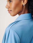 Model showcasing the back of the Cool Intentions Blazer featuring architectural batwing sleeves.