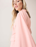 A model showcasing the Cool Intentions Blazer with batwing sleeves and satin lapels, highlighting its sleek design.