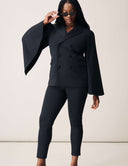 Model wearing the Cool Intentions Pant with a stylish jacket and sunglasses.